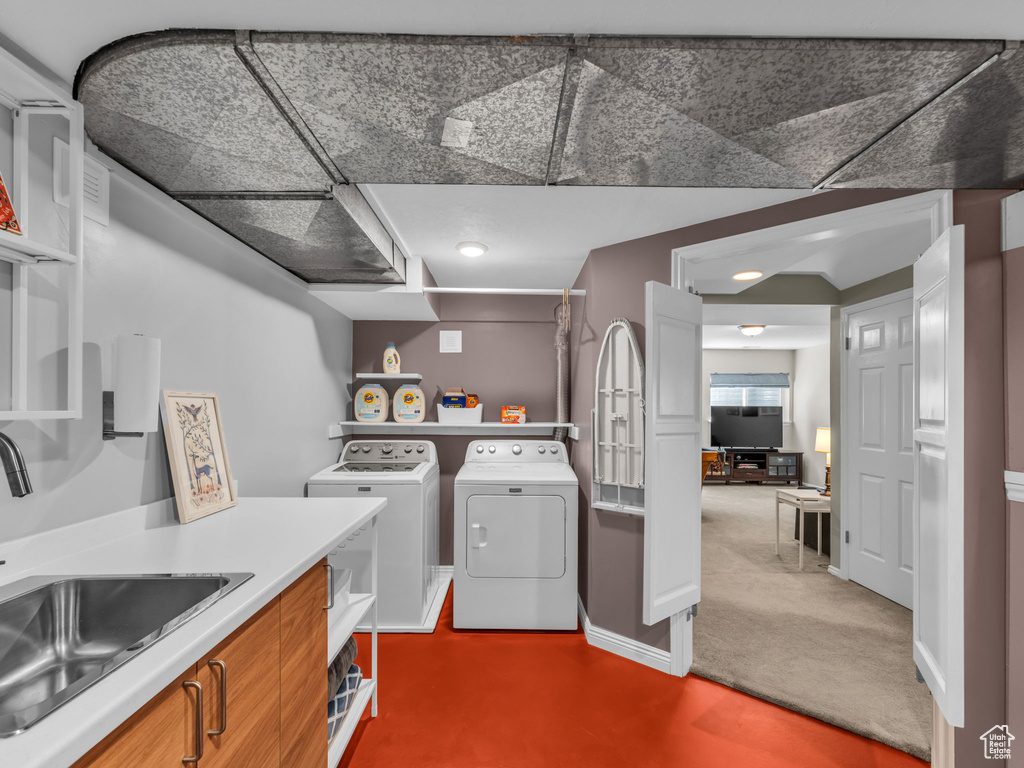 Laundry area featuring washer and clothes dryer and carpet flooring