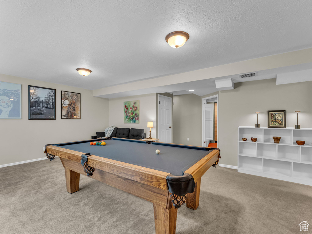 Game room with carpet, pool table, and a textured ceiling