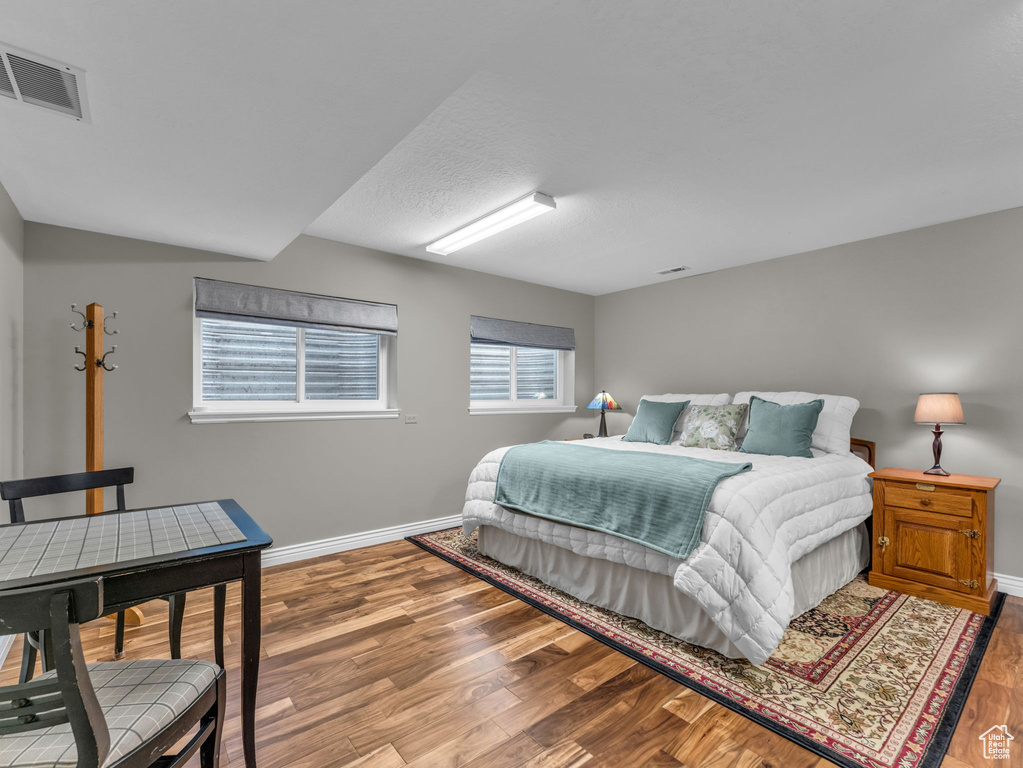 Bedroom with baseboards and wood finished floors