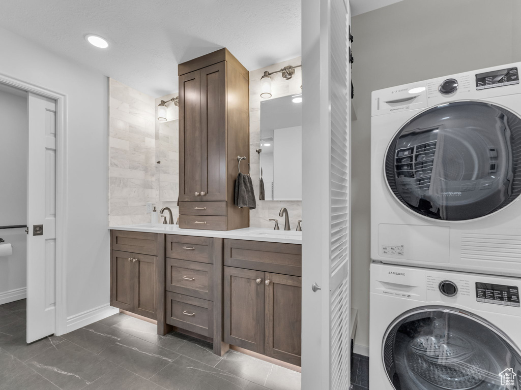 Laundry room featuring stacked washer and clothes dryer