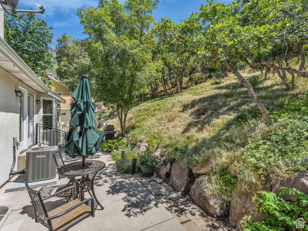 View of patio / terrace featuring view of wooded area