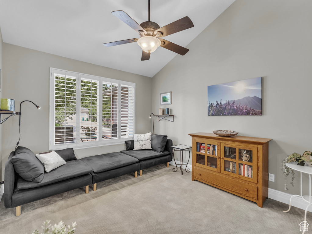 Living room featuring carpet, a ceiling fan, and high vaulted ceiling