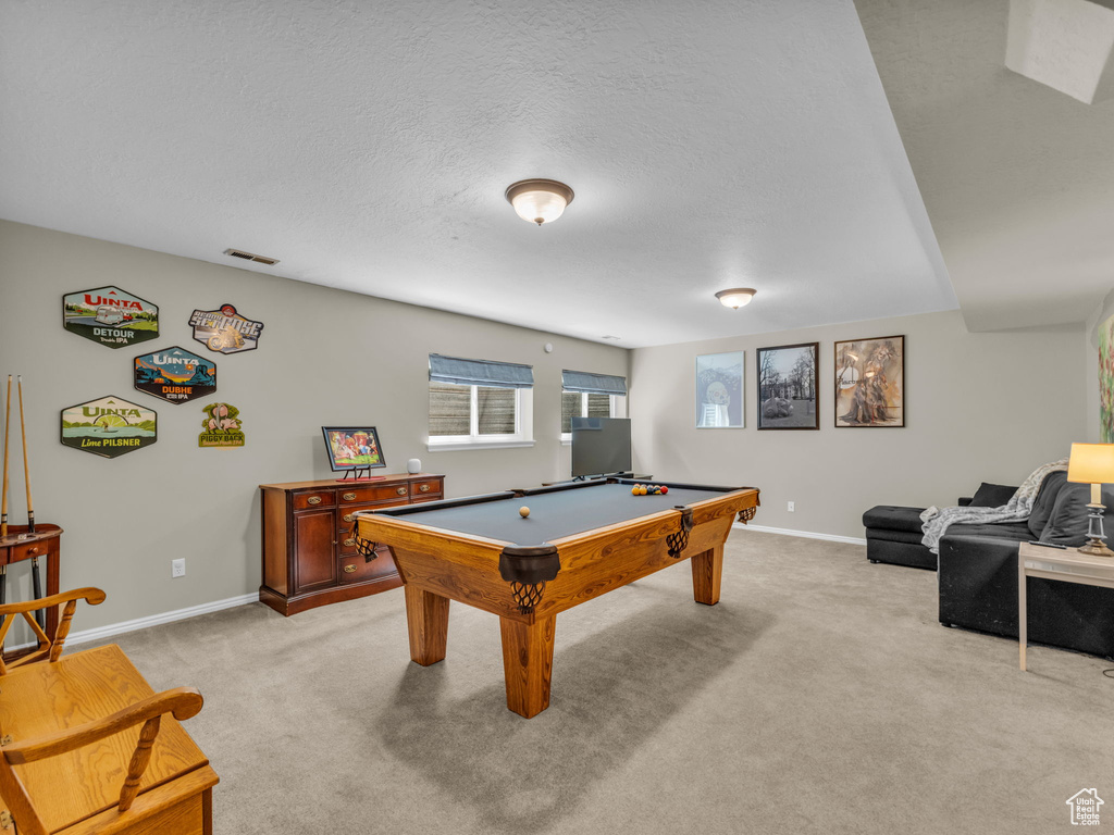Rec room featuring light carpet, pool table, and a textured ceiling