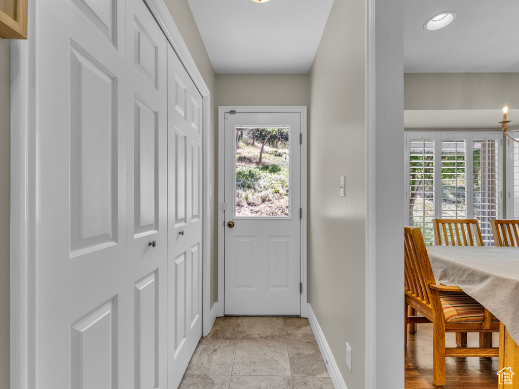 Doorway to outside with a chandelier and recessed lighting