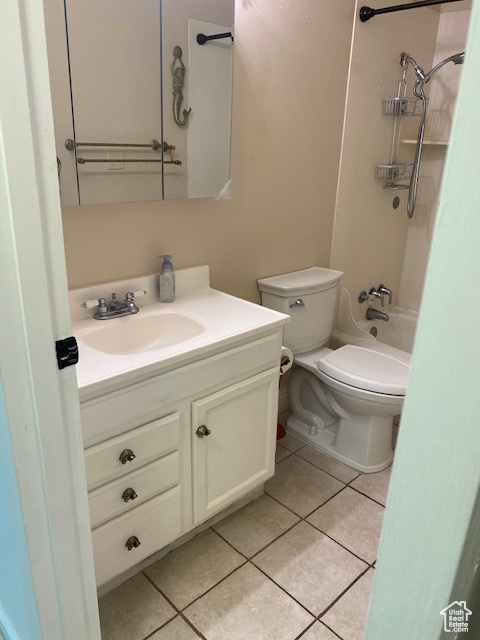 Bathroom featuring vanity, tile patterned floors, and shower / bathtub combination