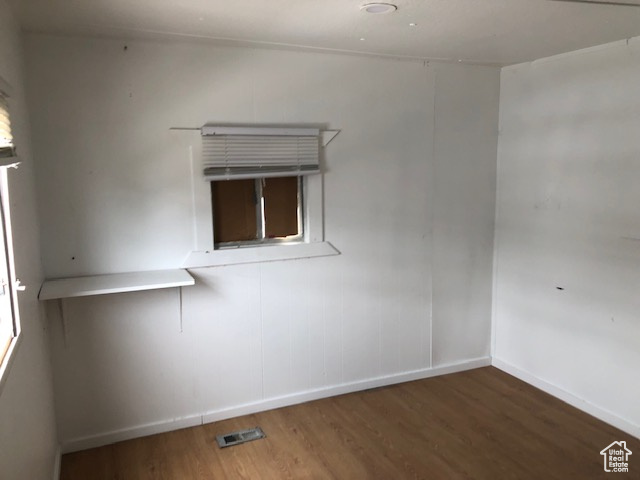 Spare room featuring wood finished floors