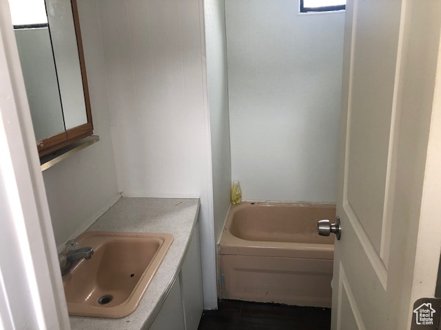 Full bathroom with a bathtub and vanity