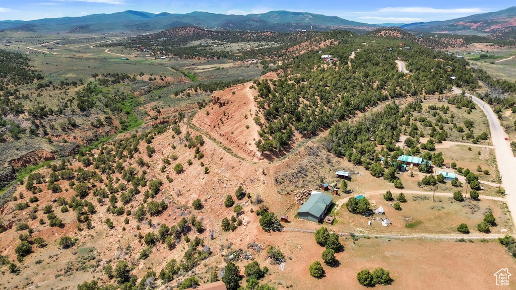 Aerial view of property and surrounding area featuring mountains