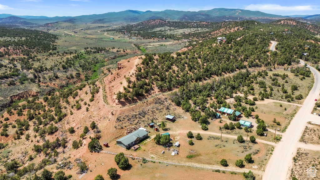 Aerial overview of property's location featuring a mountainous background