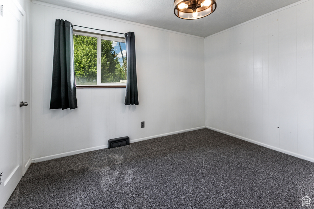 Carpeted spare room with baseboards
