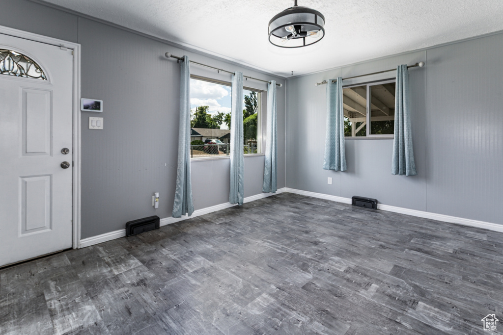 Foyer with wood finished floors and a textured ceiling