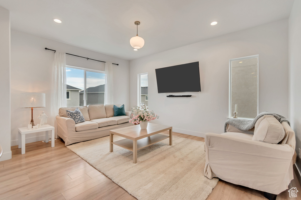 Living room featuring light wood-style flooring and recessed lighting
