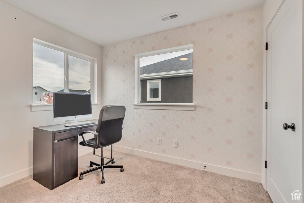 Carpeted office space featuring baseboards