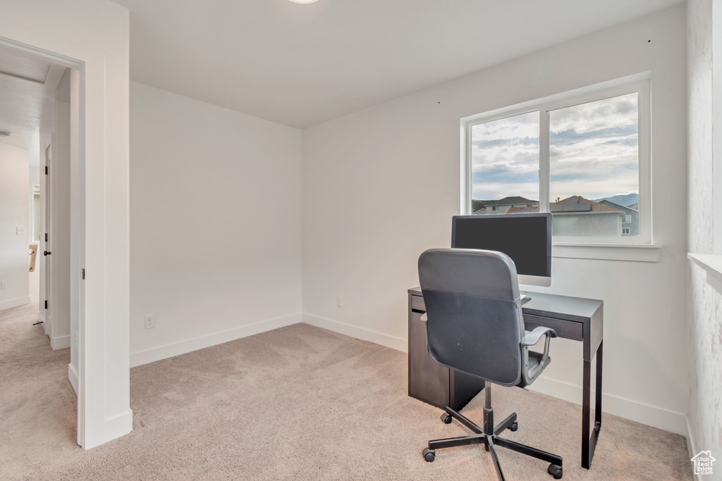 Office area featuring carpet floors and baseboards