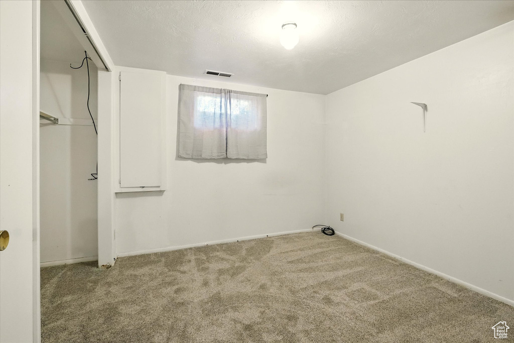 Unfurnished bedroom with carpet and a closet