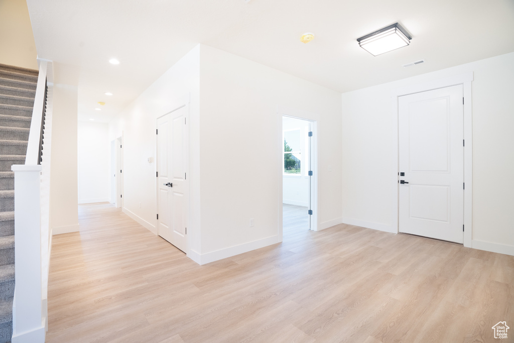 Foyer featuring stairway, light wood-style flooring, and recessed lighting