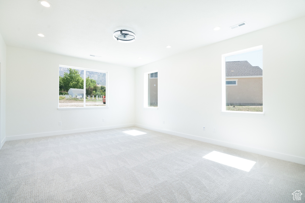 Spare room with light colored carpet and recessed lighting
