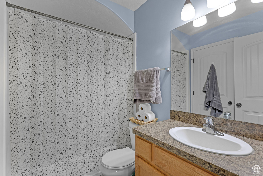 Full bath featuring vanity and curtained shower