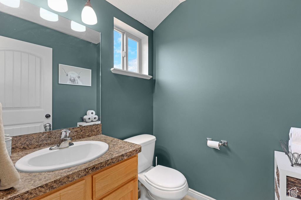 Half bathroom featuring toilet and vanity