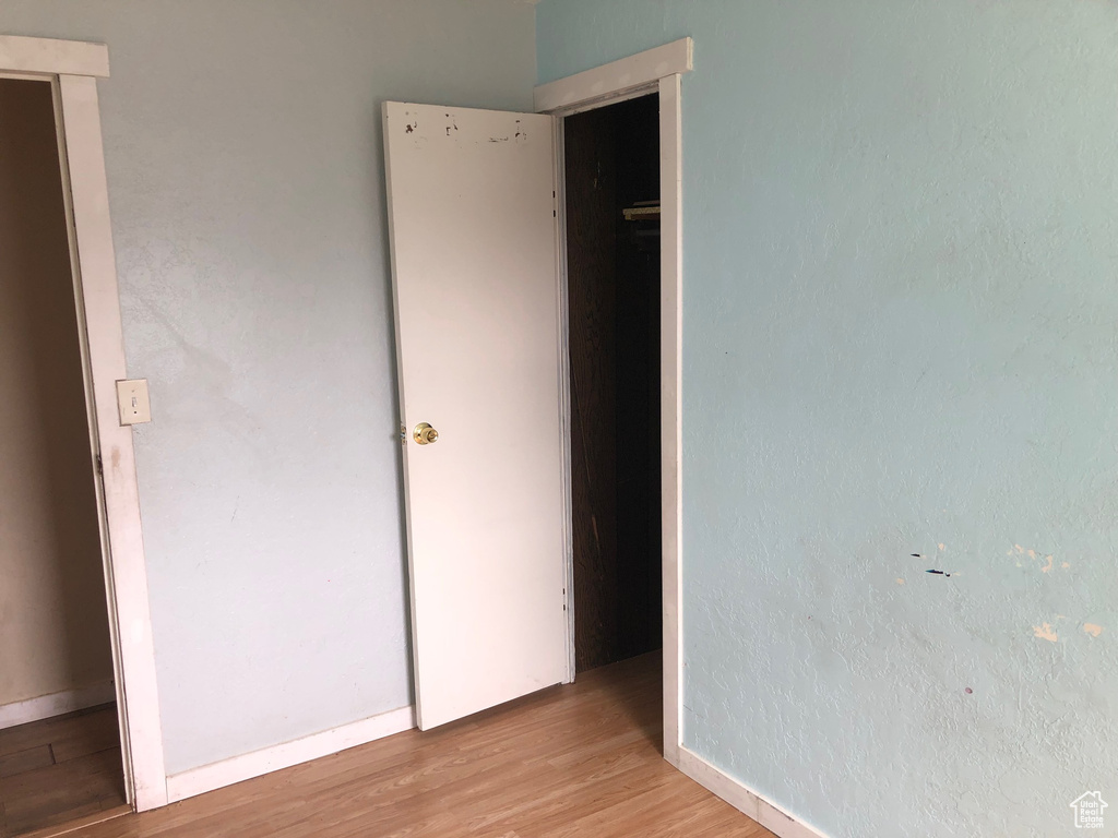 Unfurnished bedroom with light wood-type flooring and baseboards
