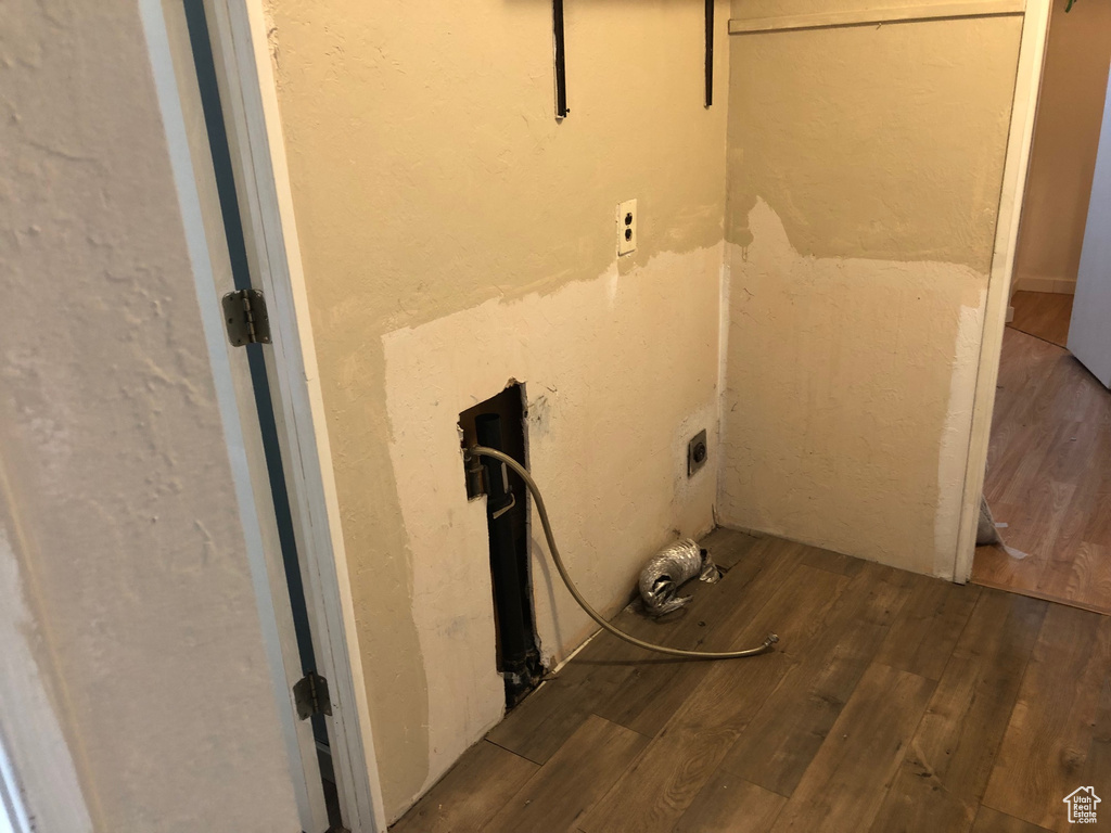 Laundry area with wood finished floors