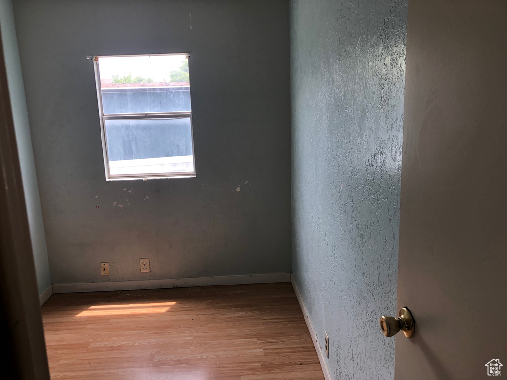 Empty room featuring wood finished floors and baseboards