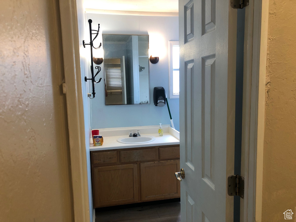 Bathroom with vanity and a textured wall