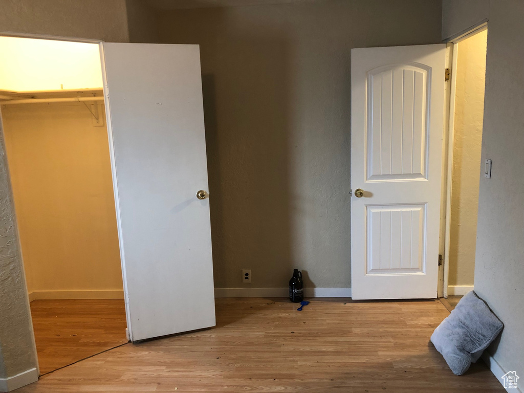 Unfurnished bedroom with light wood-style flooring and a closet