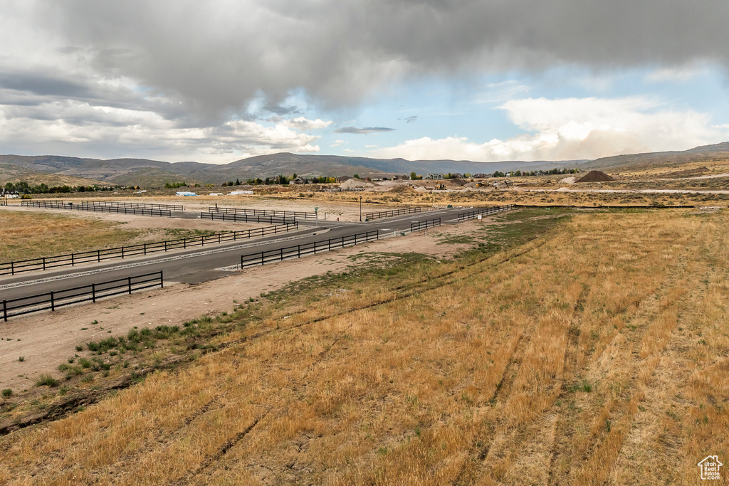 View of yard featuring a rural view and a mountain view