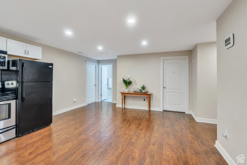 Kitchen featuring stainless steel appliances, recessed lighting, dark wood-style flooring, and white cabinets