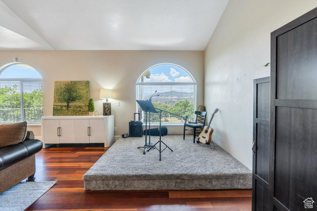 Living room featuring lofted ceiling and wood finished floors