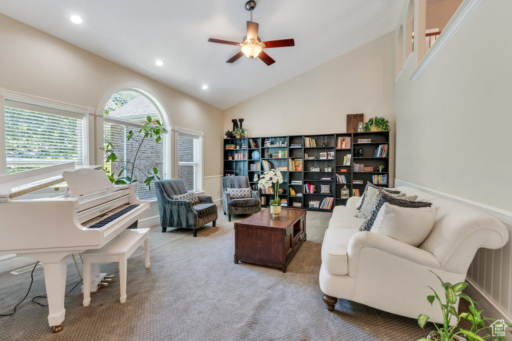 Living area with ceiling fan, carpet flooring, recessed lighting, and high vaulted ceiling