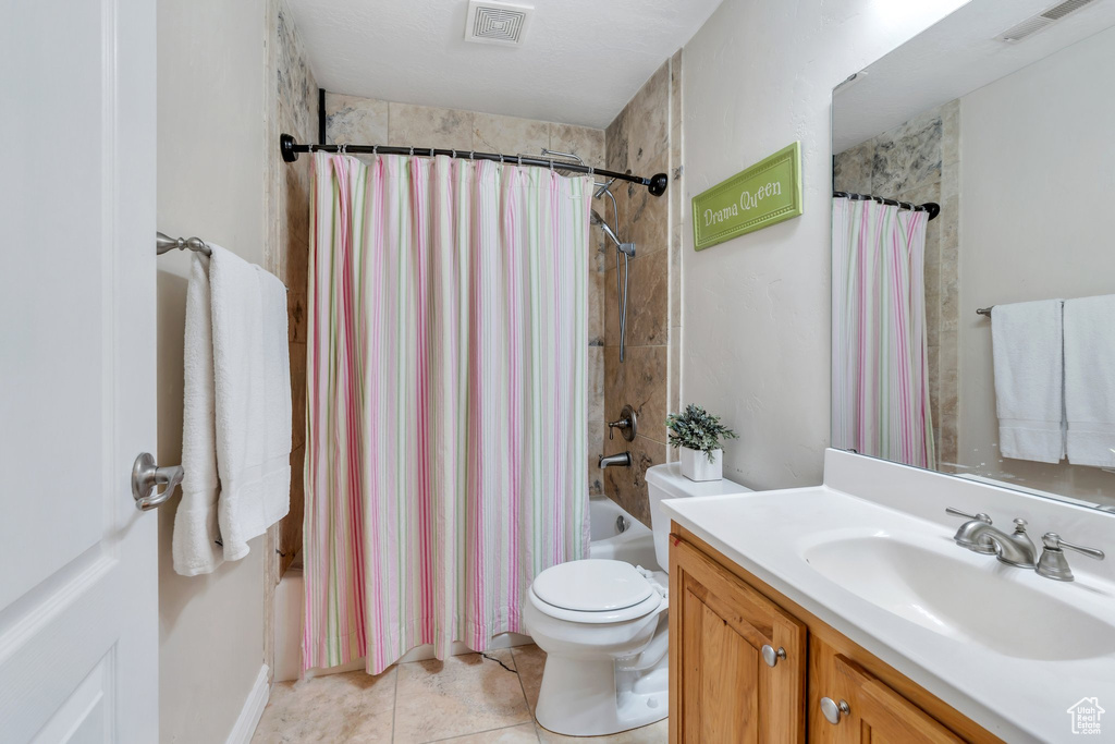 Full bathroom with vanity, shower / tub combo with curtain, and tile patterned flooring