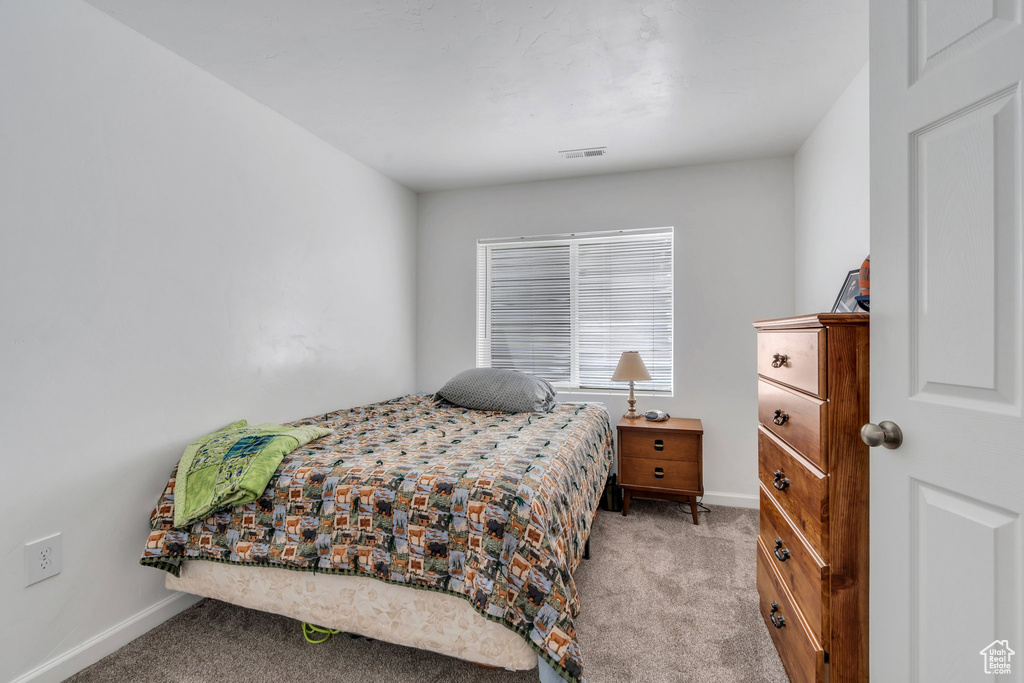 Carpeted bedroom with baseboards