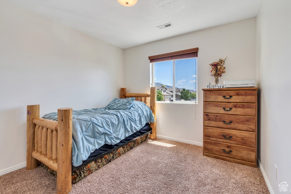 Carpeted bedroom with baseboards