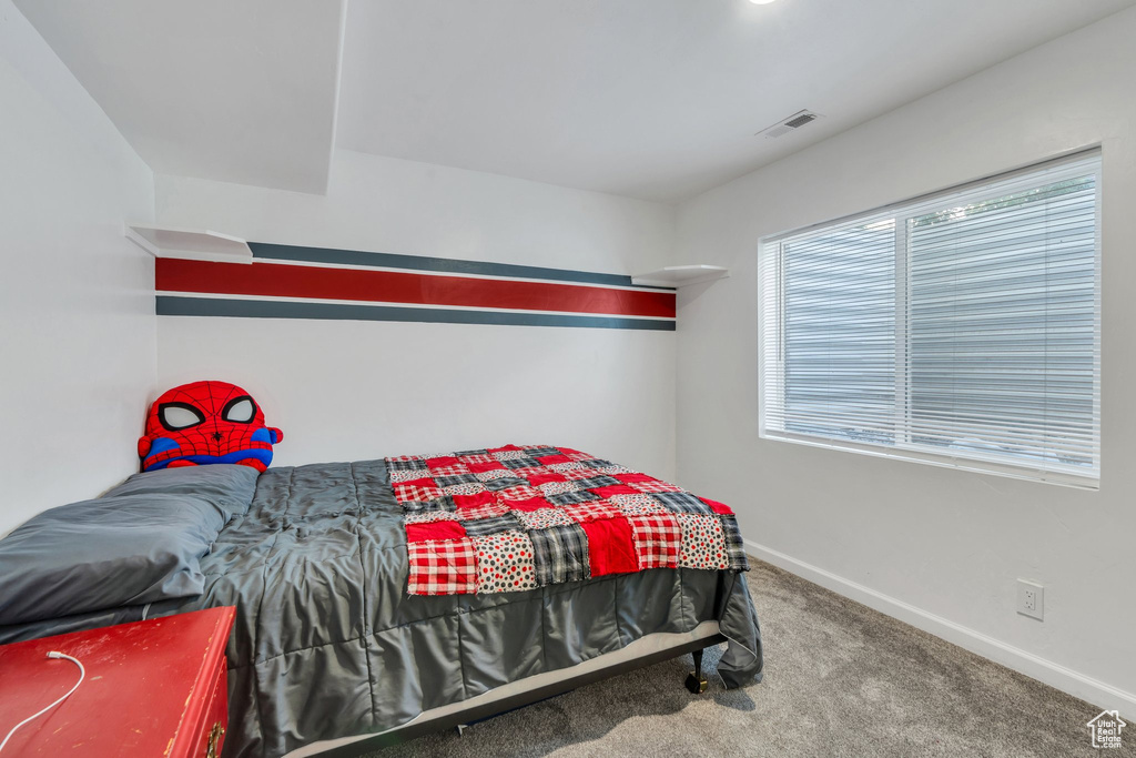 Carpeted bedroom with baseboards