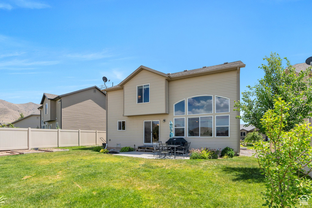Rear view of property with a patio