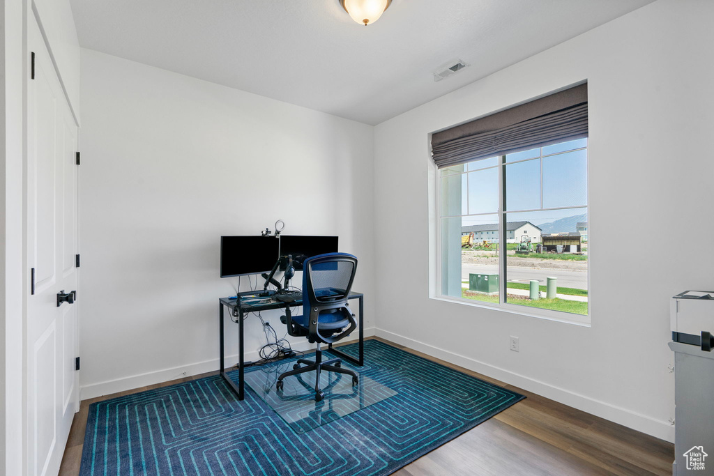 Office area featuring wood finished floors and baseboards