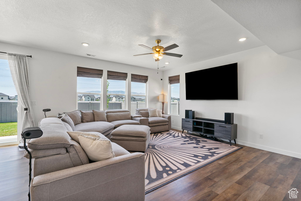 Living room with recessed lighting, wood finished floors, a ceiling fan, and a textured ceiling