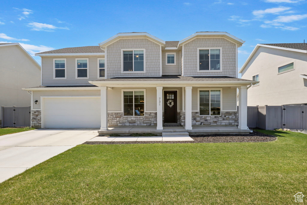 Craftsman inspired home featuring a gate, a porch, stone siding, and concrete driveway