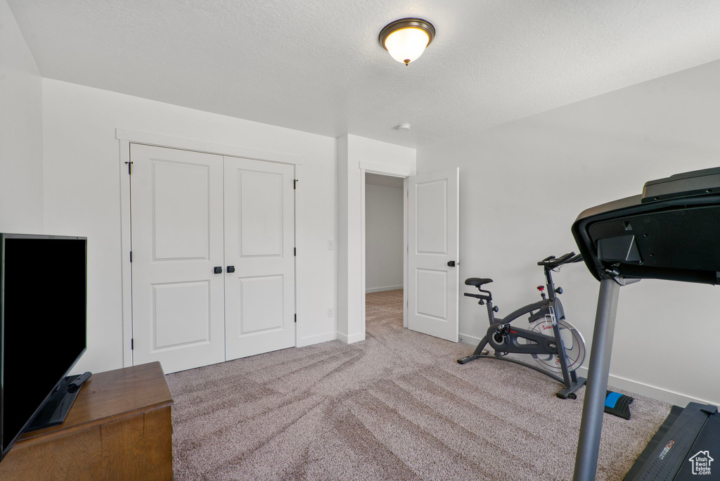 Workout area with carpet and baseboards