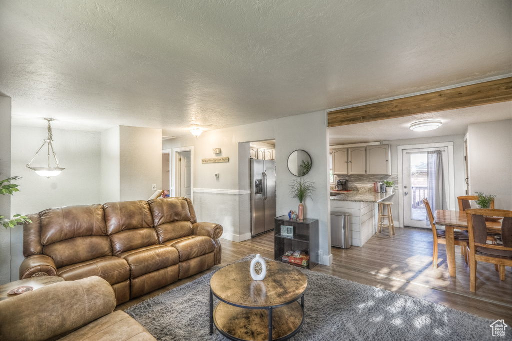 Living room featuring a textured ceiling and wood finished floors