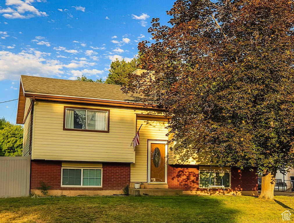 View of front of property with entry steps and brick siding