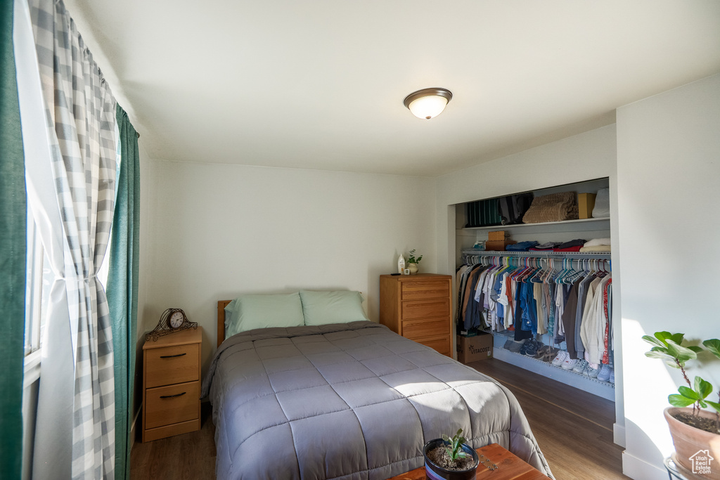 Bedroom featuring wood finished floors and a closet