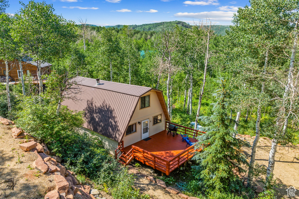 View of subject property with a forest