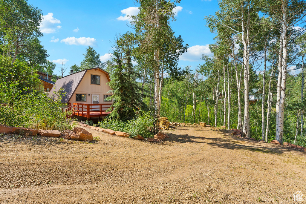 View of yard with a wooden deck