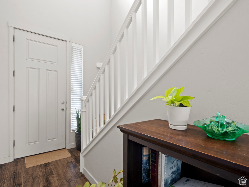 Foyer entrance with stairway and wood finished floors
