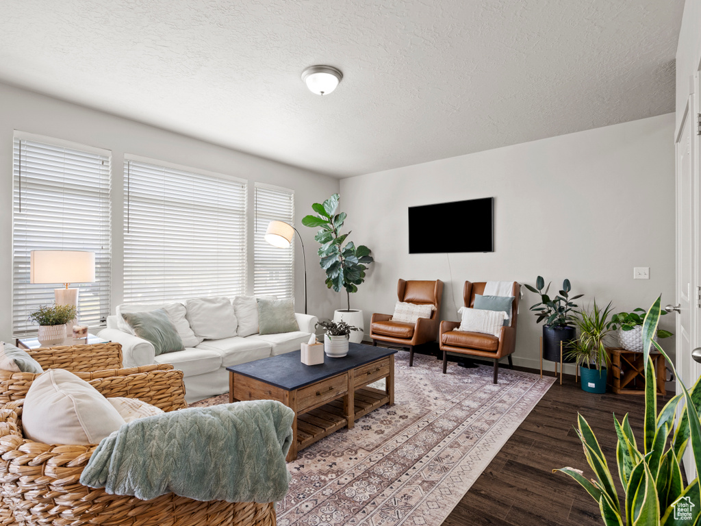 Living area featuring wood finished floors and a textured ceiling