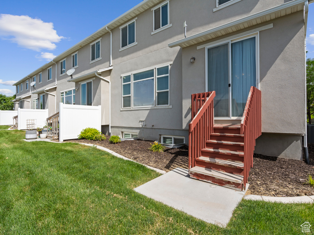 Rear view of property with stucco siding
