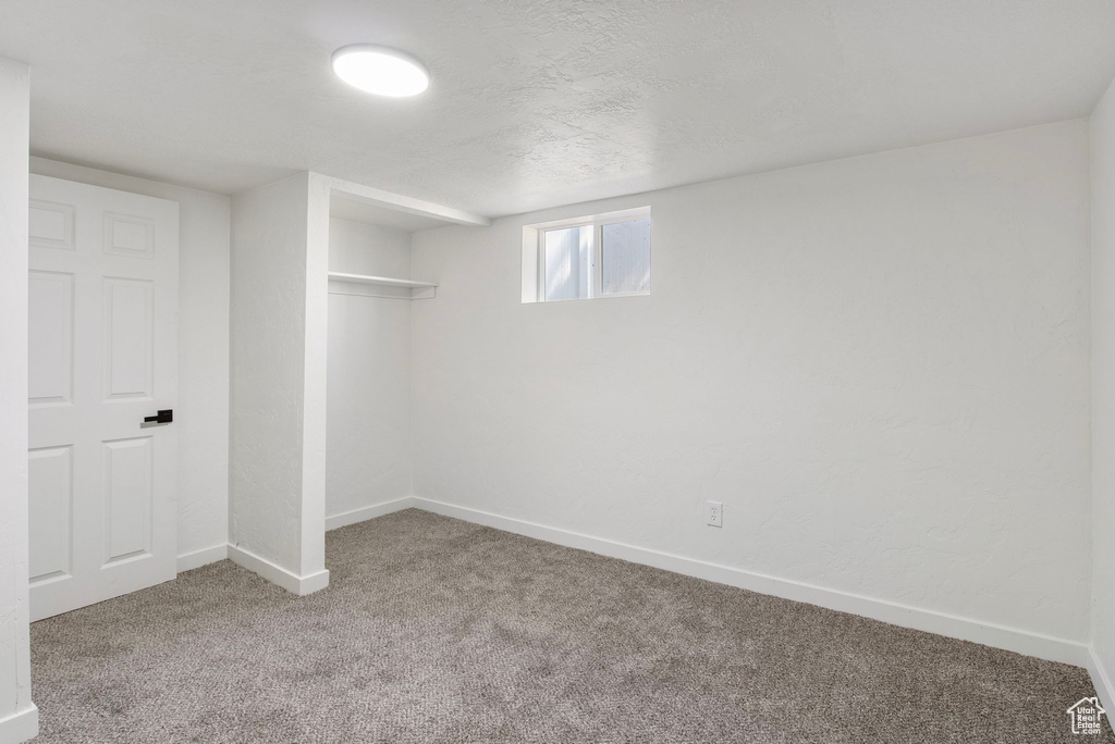 Below grade area with carpet floors and baseboards